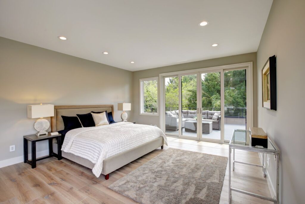 A home addition bedroom with sliding glass doors.